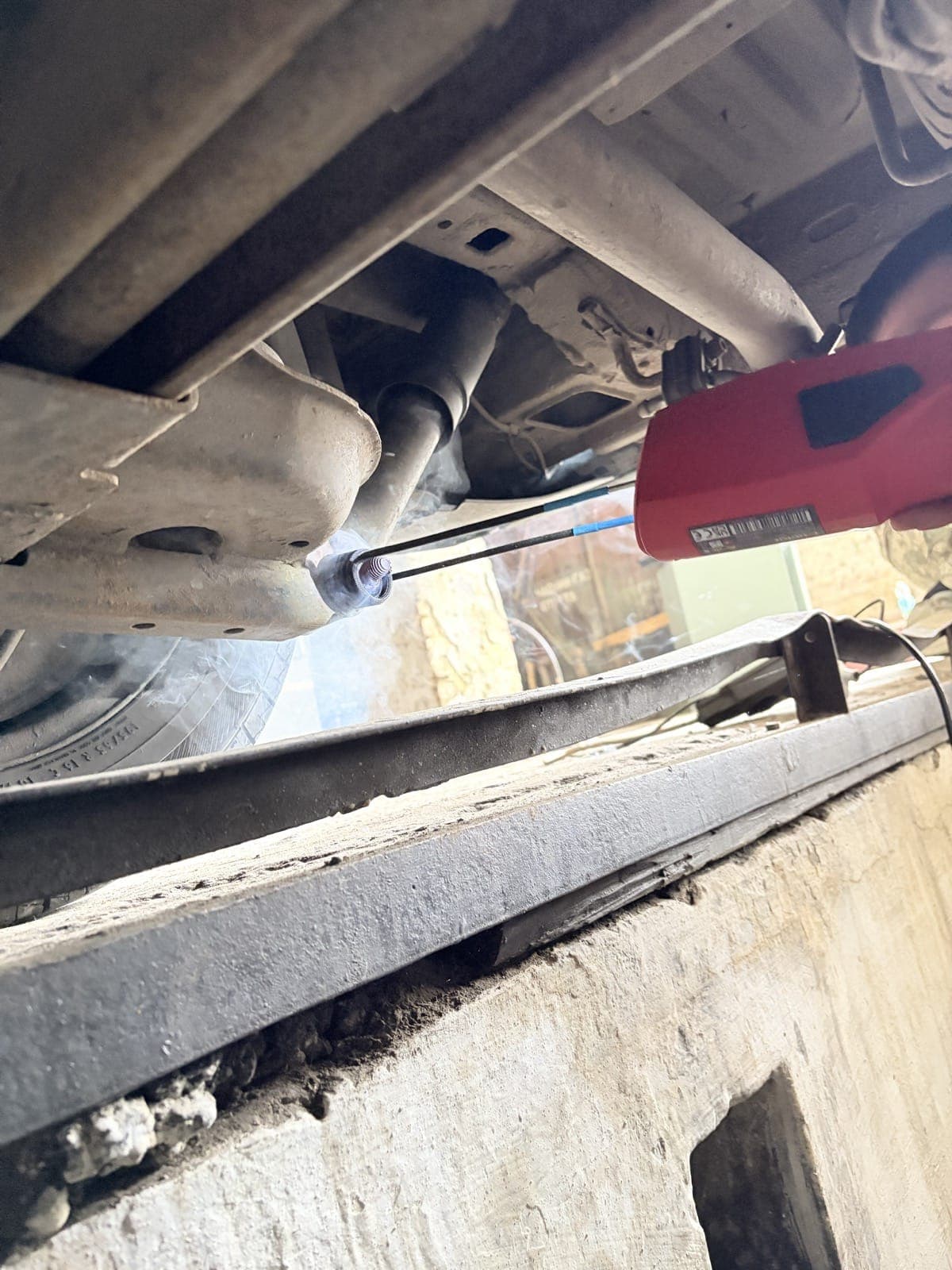 Induction heater being used under a vehicle during repair